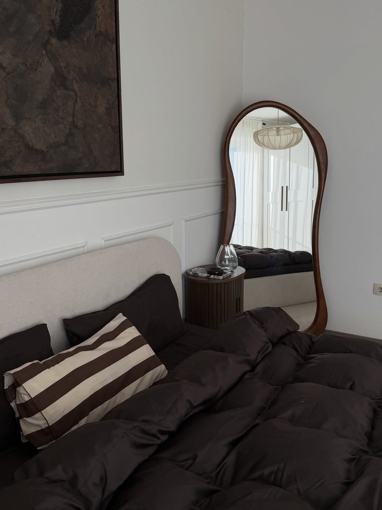 Bedroom Decor Ideas with dark brown duvet boucle headboard and walnut framed arch mirror