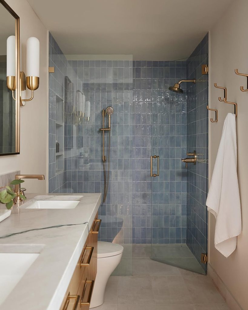 Blue Bathroom Ideas with slate blue zellige tile shower and brushed brass fixtures